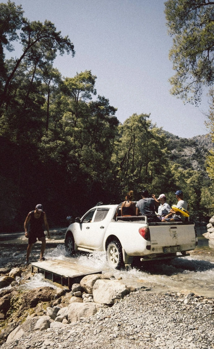 people standing beside white crew cab pickup truck during daytime